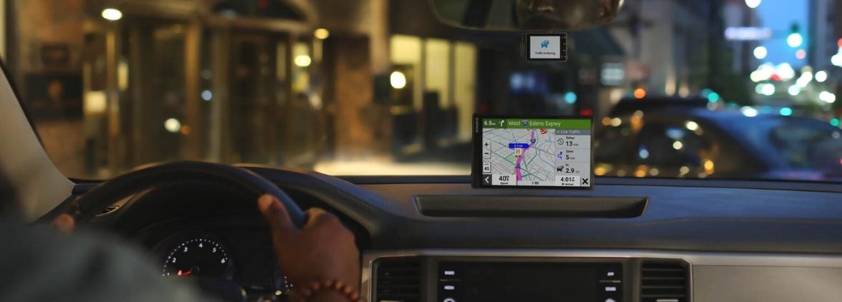 Garmin SmartDrive GPS Navigator Mounted In Car Driving At Night