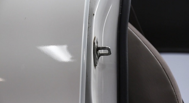 The metal door latch is a reliable ground point.